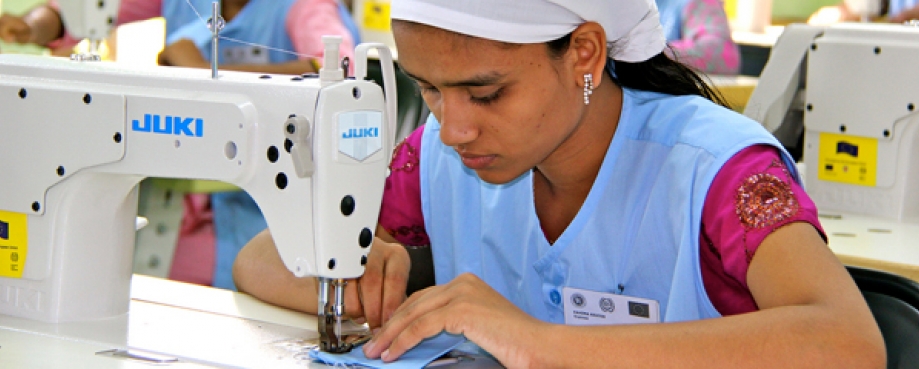 Female garment factory worker at a sewing machine, Bangladsh