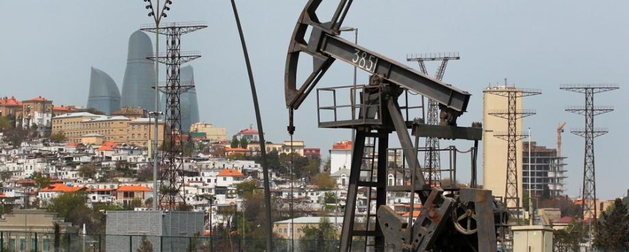 Oil pumpjack in seaside park overlooking the Baku skyline where COP29 is taking place. Photo credit: Shutterstock.