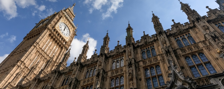 A photograph of the houses of parliament looking up at Big Ben's clockface and a blue sky with wisps of cloud. Photo credit: Shutterstock.