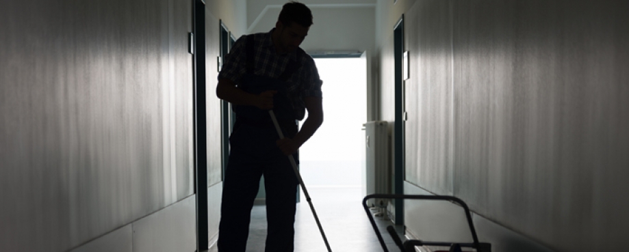 Male cleaner, mopping a floor