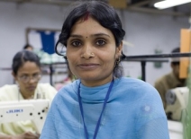 Female garment worker on a factory sewing floor, India