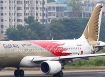Plane on Dhaka airport runway, with high-rise buildings in background
