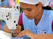 Female garment factory worker at a sewing machine, Bangladsh
